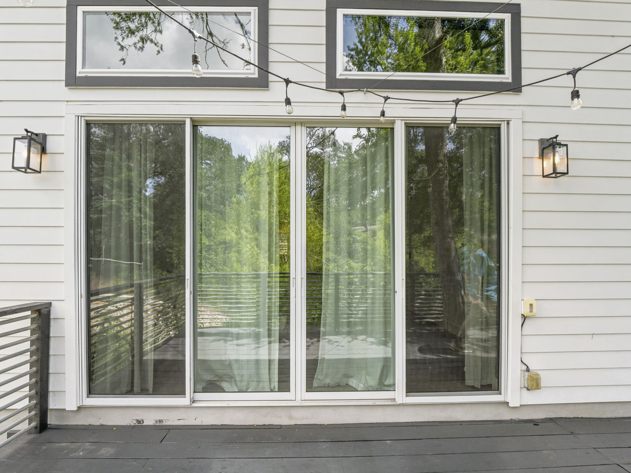 5005 Lott Avenue, Unit 2 Austin, TX 78721 - Photo 18 of 25 A spacious outdoor deck with sliding glass doors offers a serene view of surrounding nature.