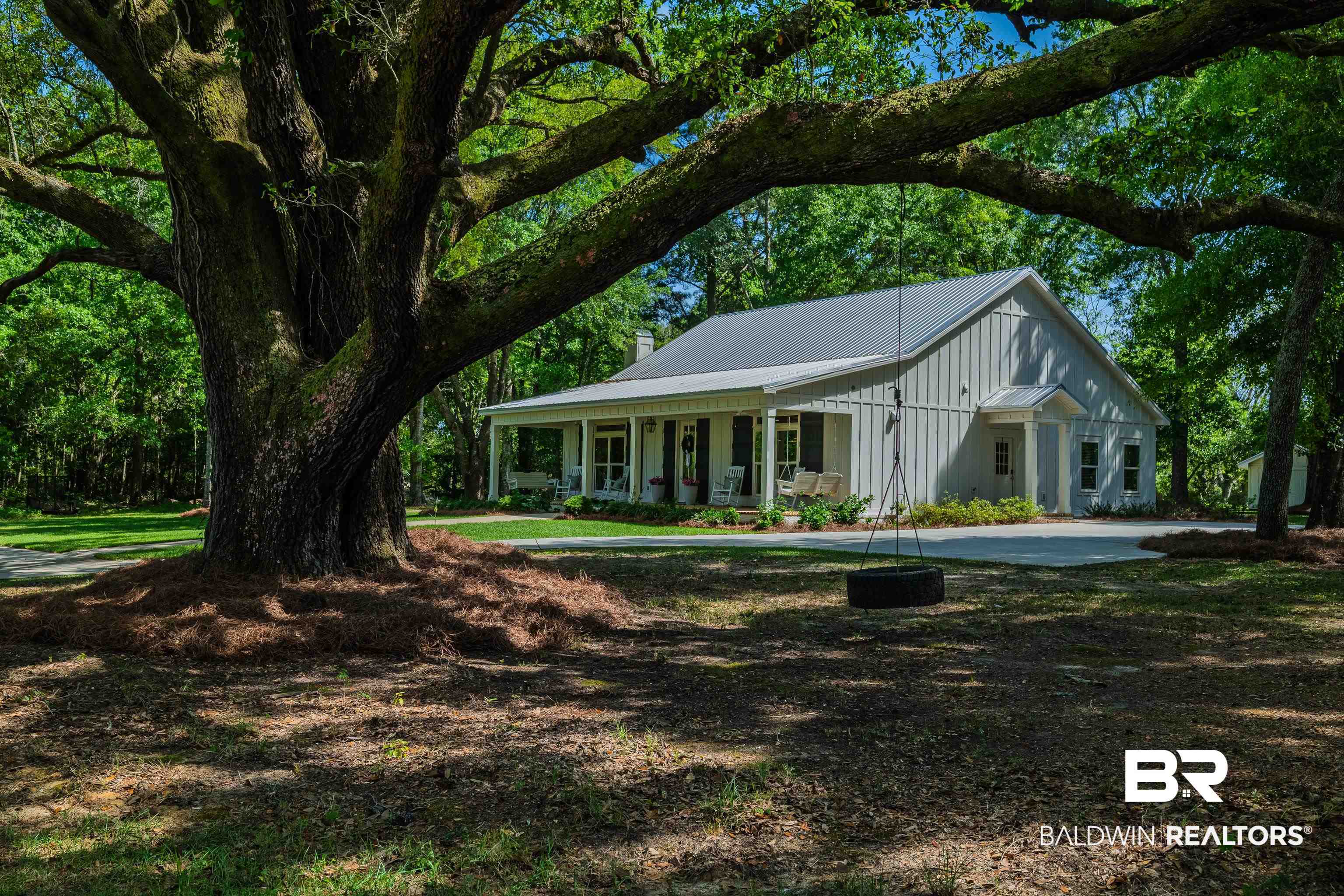 19121 Boothe Road Fairhope, AL 36532 - Photo 35 of 41 View of front of home featuring covered porch, a chimney, a metal roof, and board and batten siding