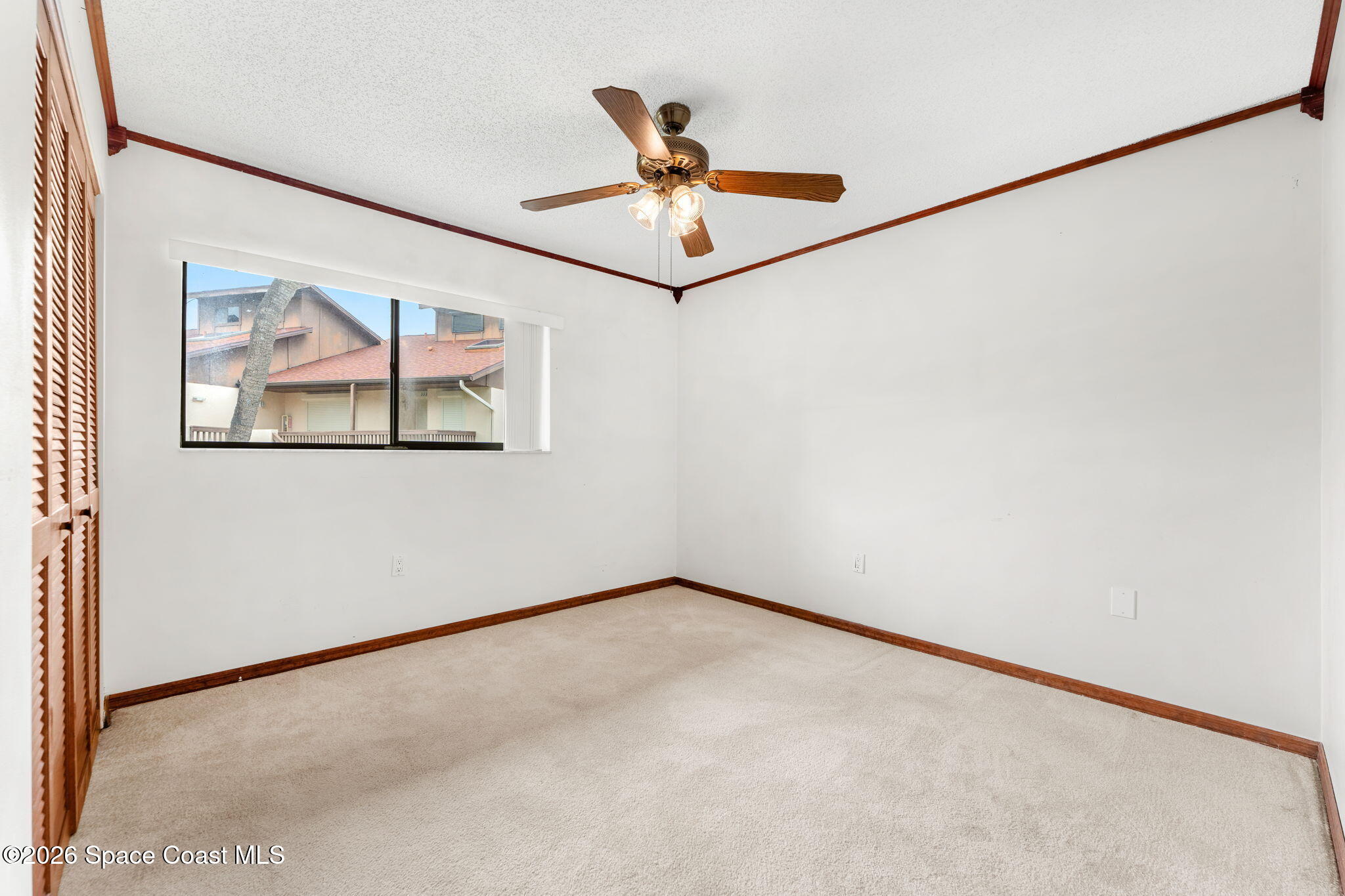 3121 Kirkland Road Northeast Palm Bay, FL 32905 - Photo 30 of 52 an empty room with a window and a ceiling fan