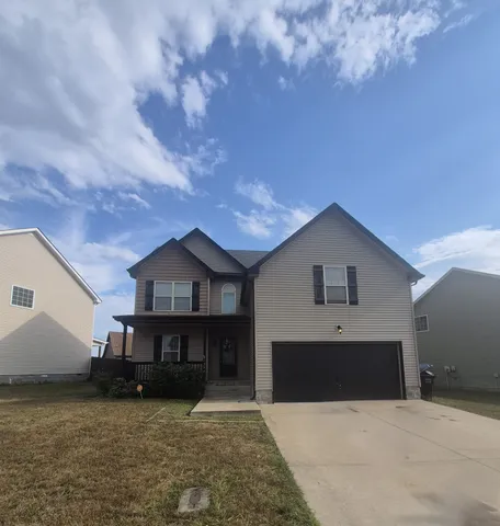 a view of a house with roof and a yard