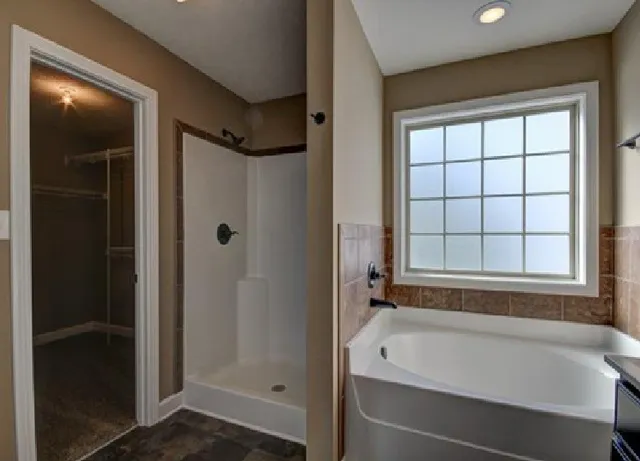 a bathroom with a bathtub and shower