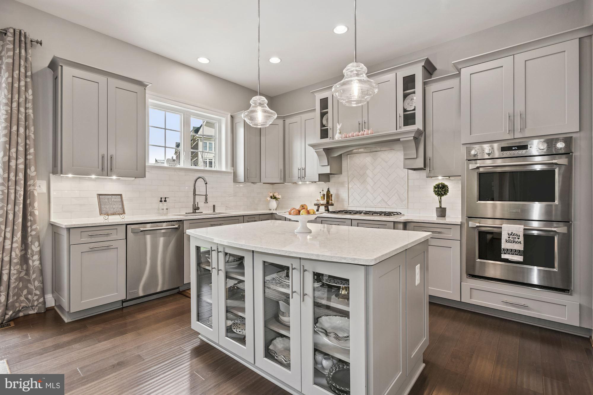 a kitchen with stainless steel appliances granite countertop a white stove top oven and sink