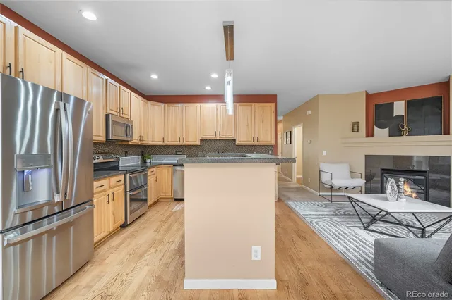 a view of a kitchen with a refrigerator wooden cabinets and a refrigerator