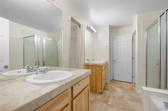 a spacious bathroom with a sink a mirror and a shower