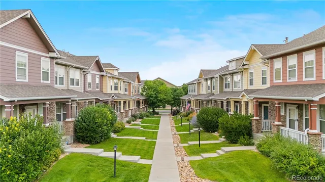 a front view of a residential apartment building with a yard