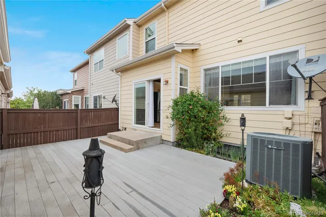 a view of a house with wooden floor and wooden fence