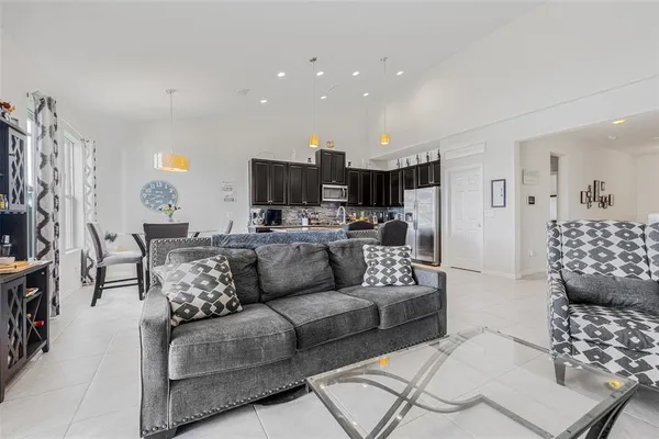 a kitchen with stainless steel appliances granite countertop a refrigerator and a stove top oven