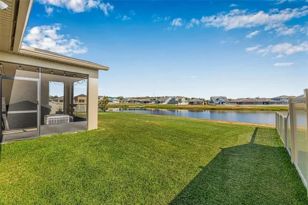 a view of a swimming pool with an outdoor seating and a yard