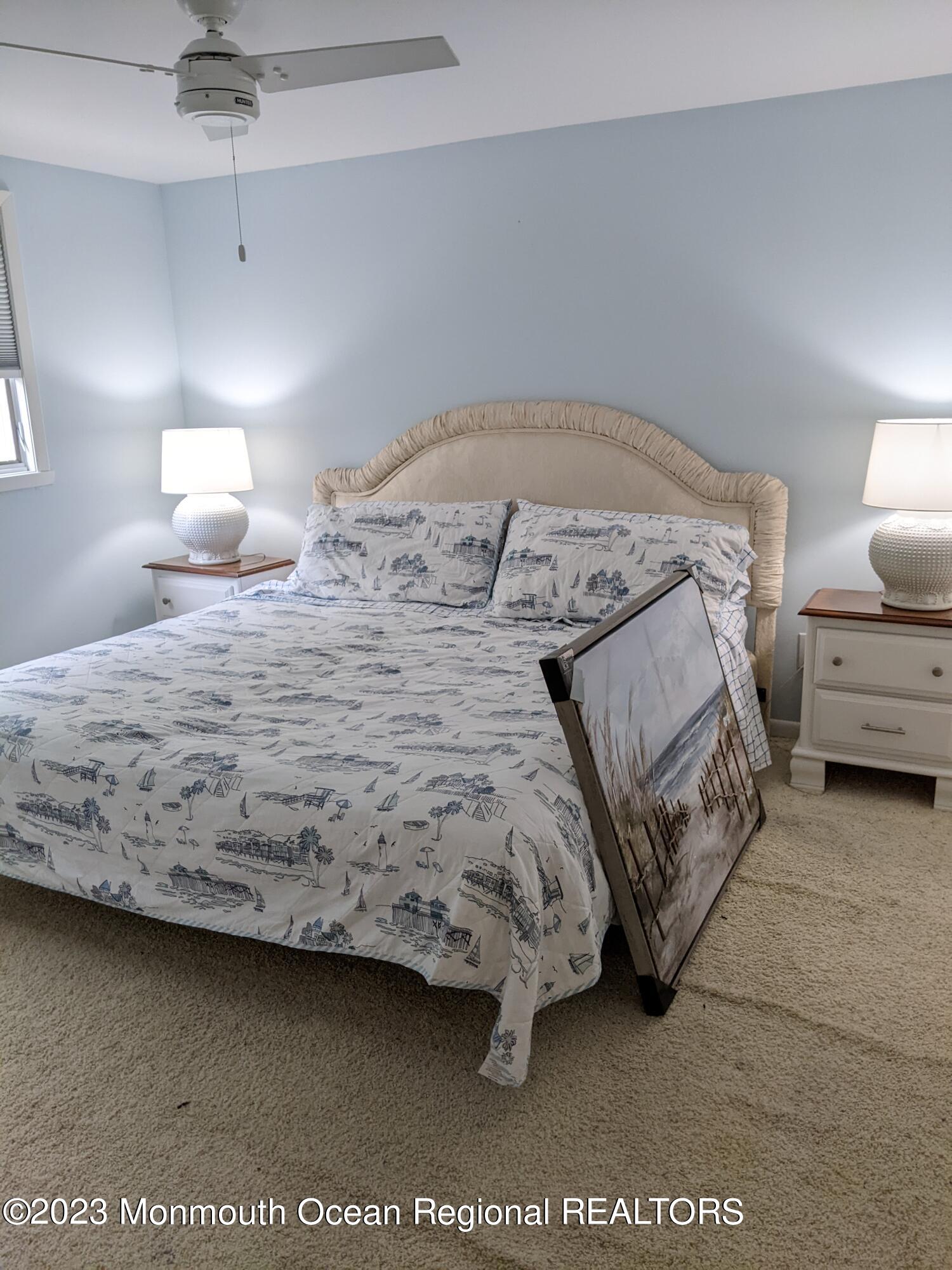 289 Monterey Circle Lavallette, NJ 08735 - Photo 13 of 32 a bedroom with a bed and a lamp