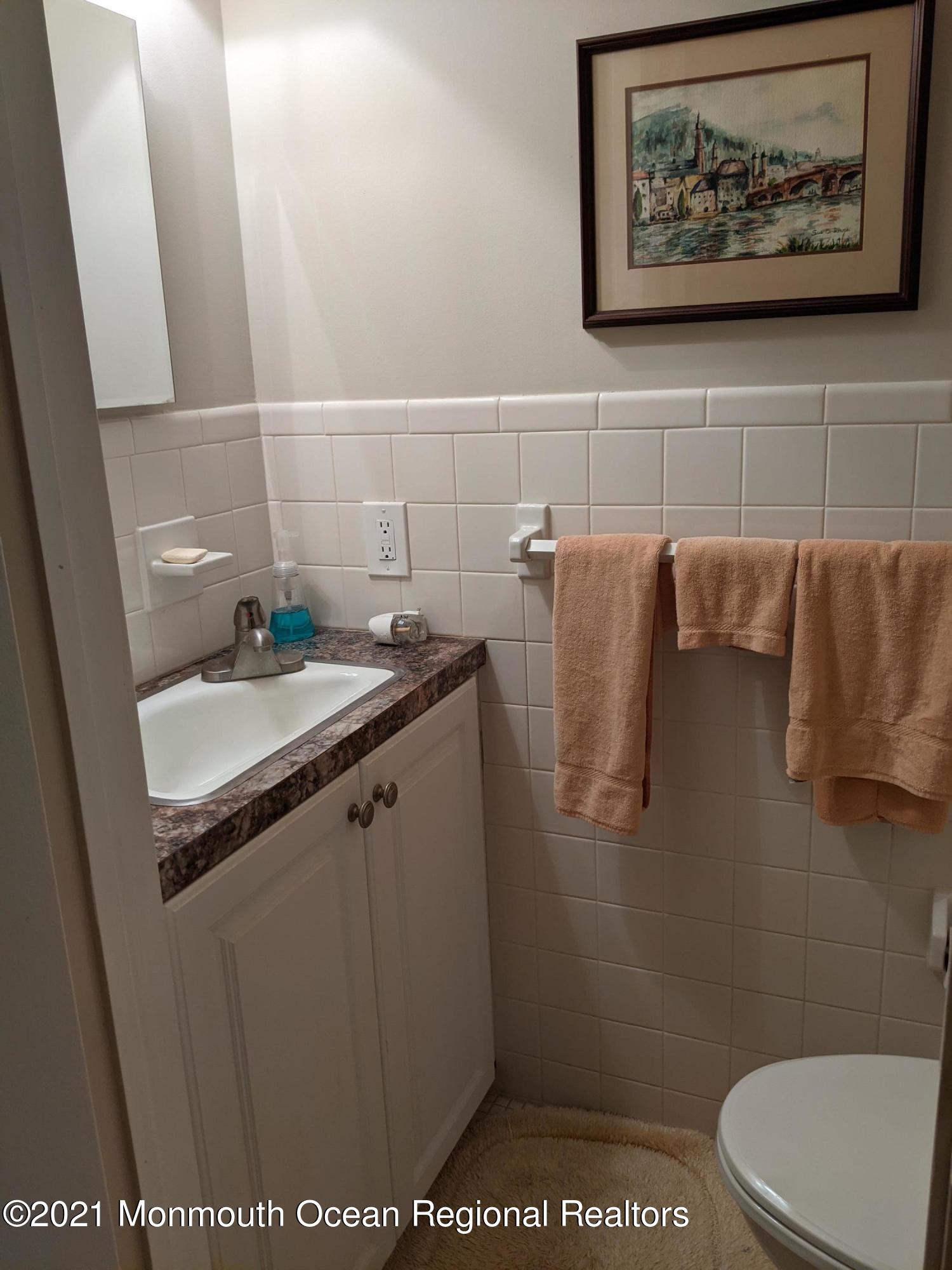 289 Monterey Circle Lavallette, NJ 08735 - Photo 16 of 32 a bathroom with a sink and a toilet