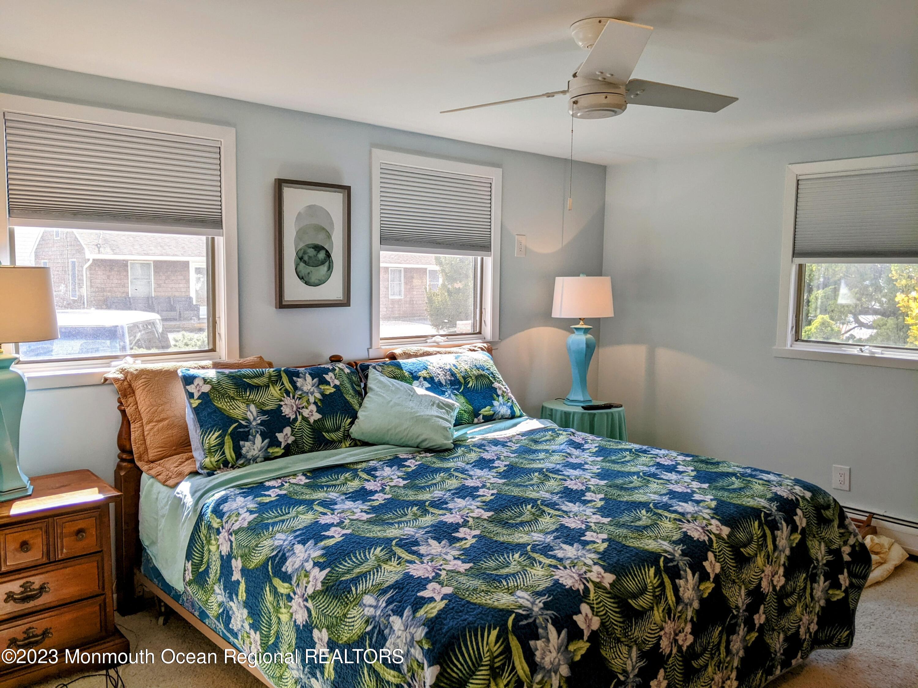 289 Monterey Circle Lavallette, NJ 08735 - Photo 8 of 32 a bedroom with a bed mirror and window