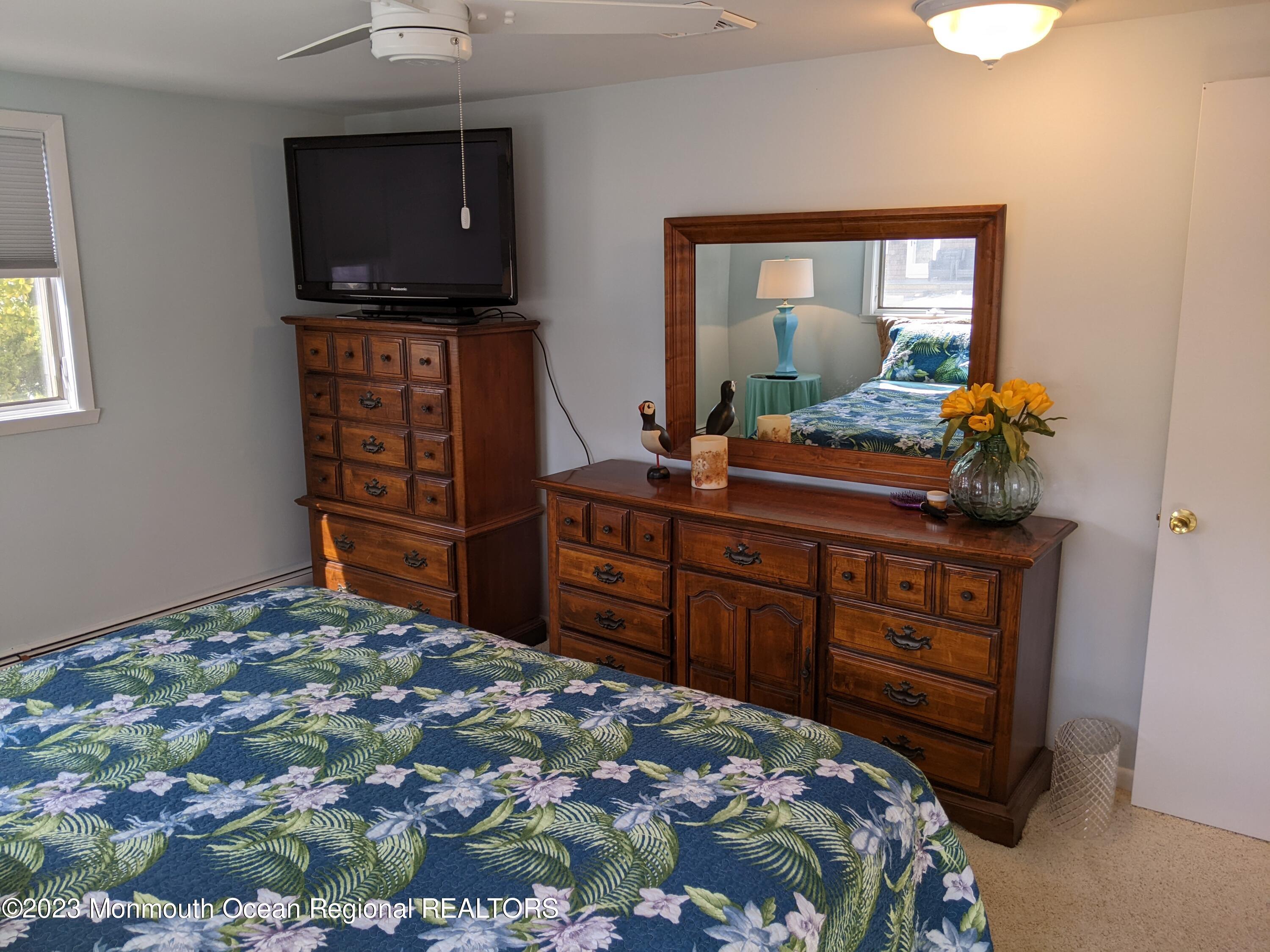 289 Monterey Circle Lavallette, NJ 08735 - Photo 9 of 32 a bedroom with a bed and a flat screen tv