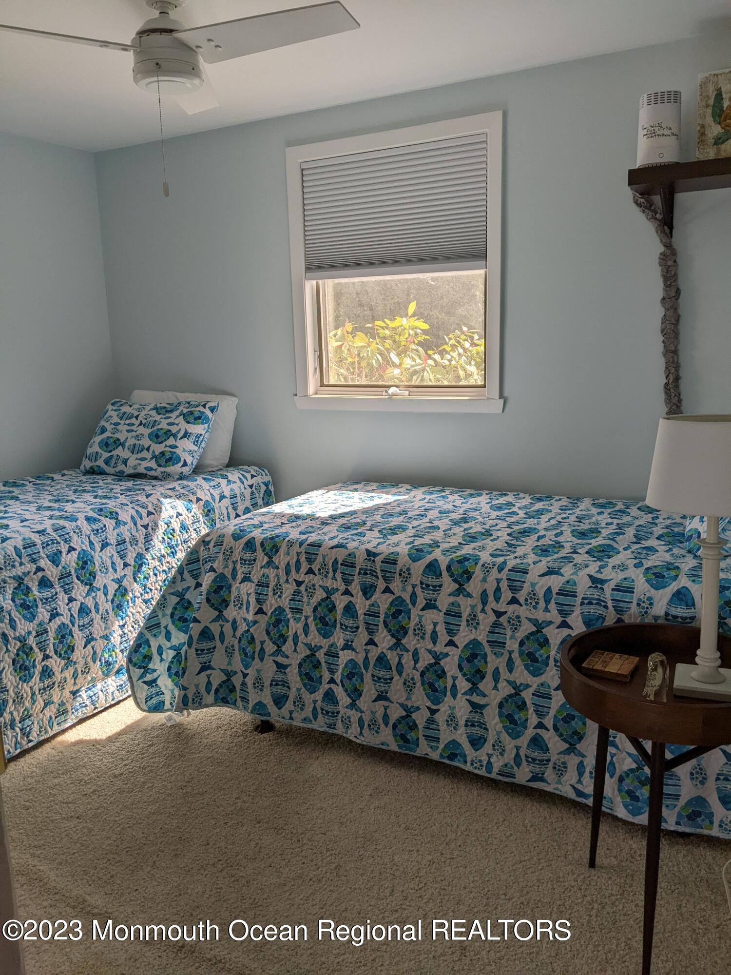 289 Monterey Circle Lavallette, NJ 08735 - Photo 10 of 32 a bedroom with a bed and a table in it