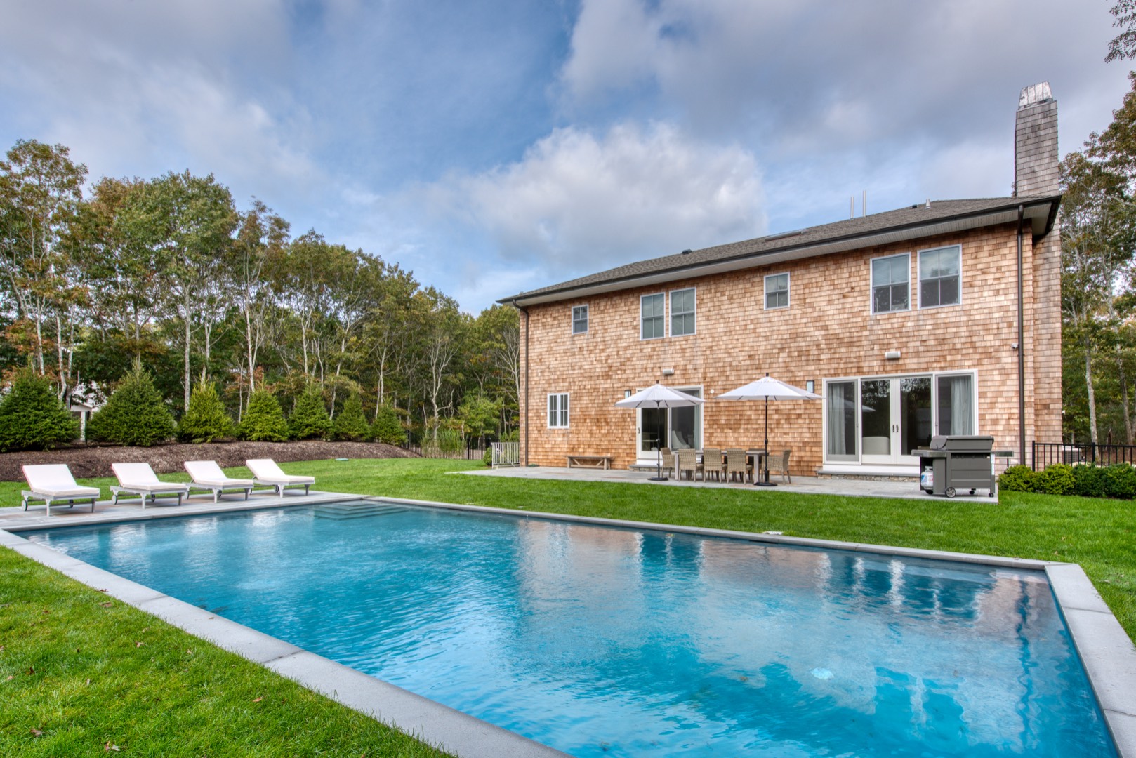 10 Dead Trail Road Water Mill, NY 11976 - Photo 2 of 19 a view of pool with garden and trees