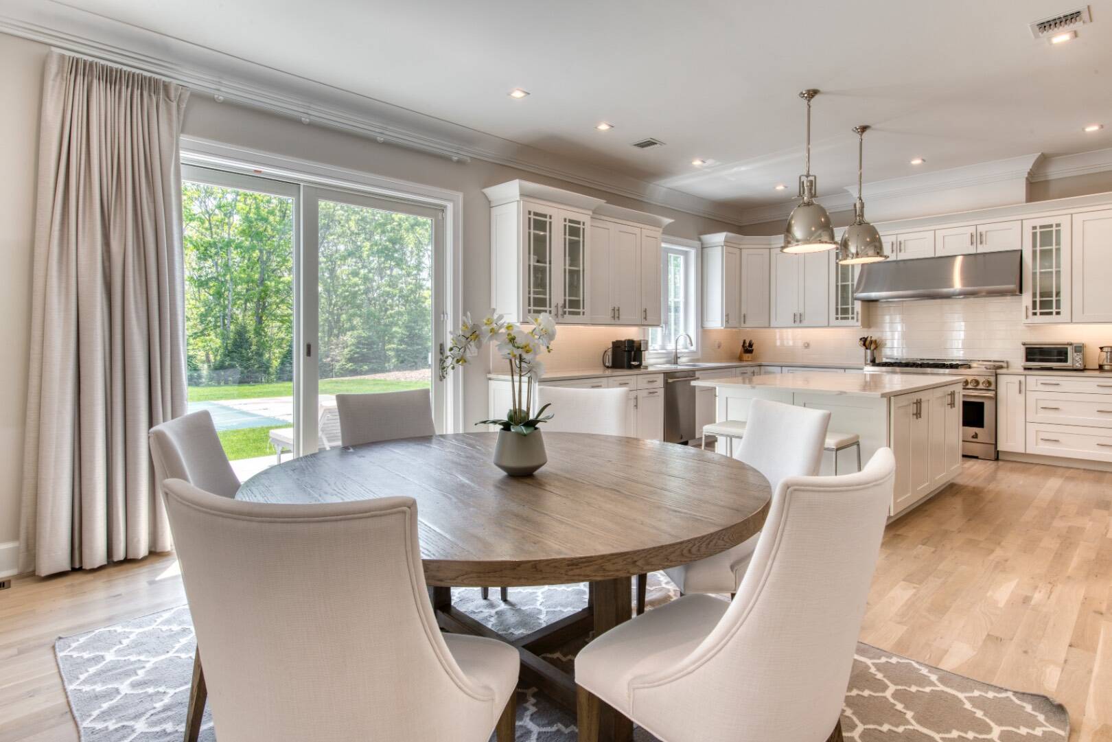10 Dead Trail Road Water Mill, NY 11976 - Photo 6 of 19 a living room with stainless steel appliances granite countertop a table chairs and a view of kitchen