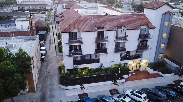an aerial view of multiple houses with a yard