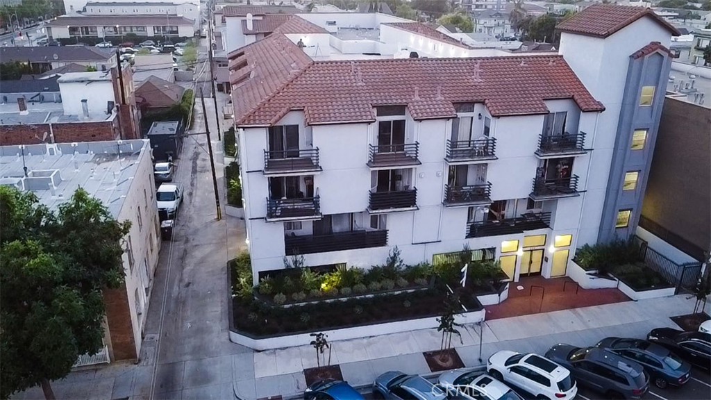 an aerial view of multiple houses with a yard