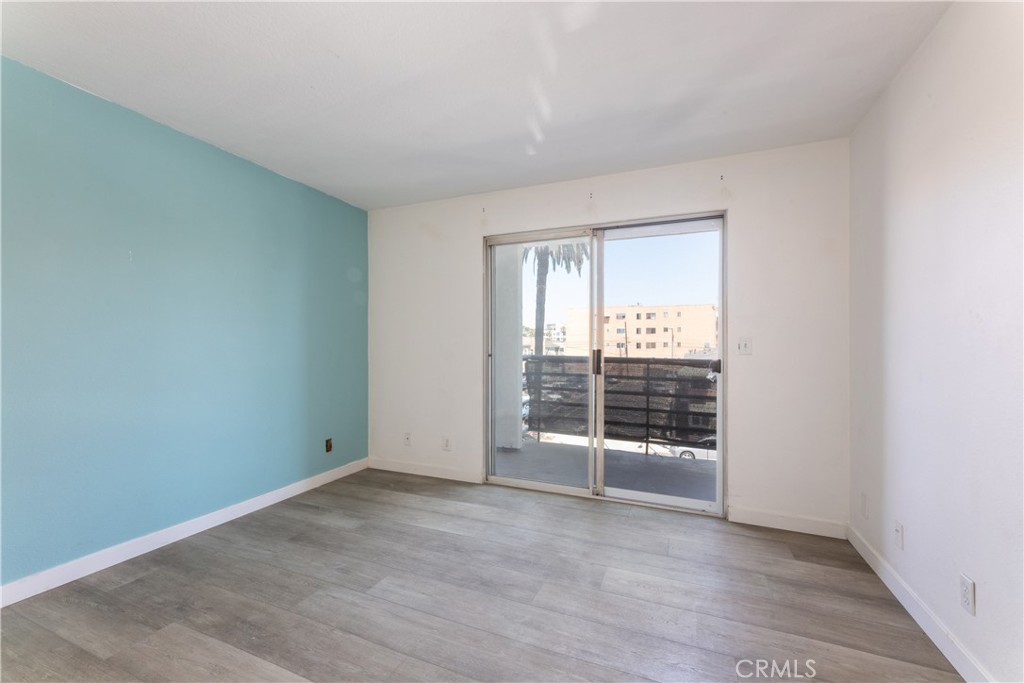 327 Chestnut Avenue, Unit 201 Long Beach, CA 90802 - Photo 17 of 29 an empty room with wooden floor and windows