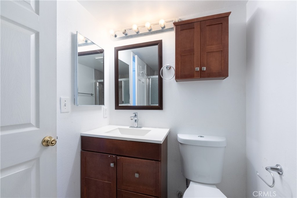 327 Chestnut Avenue, Unit 201 Long Beach, CA 90802 - Photo 21 of 29 a bathroom with a toilet sink and mirror