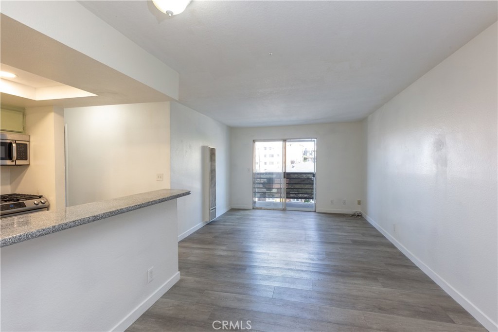 327 Chestnut Avenue, Unit 201 Long Beach, CA 90802 - Photo 4 of 29 an empty room with wooden floor and windows