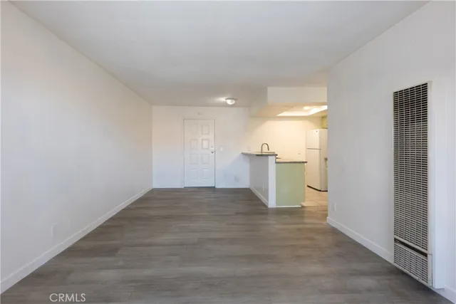 a view of a kitchen with a sink and a refrigerator