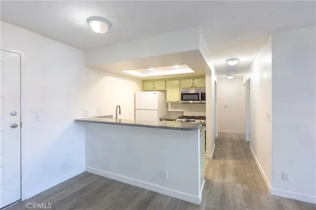 a kitchen with stainless steel appliances a refrigerator and a sink