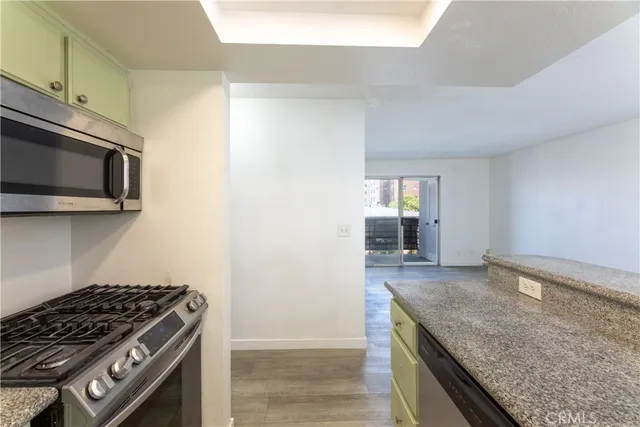 a kitchen with granite countertop a stove and a microwave