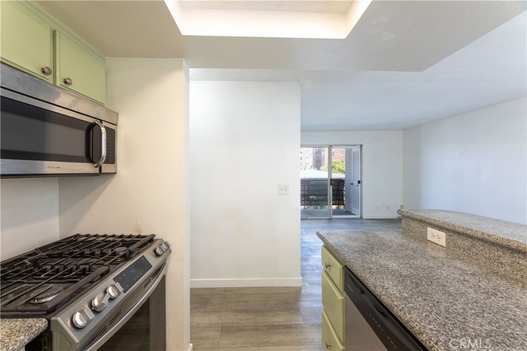 327 Chestnut Avenue, Unit 201 Long Beach, CA 90802 - Photo 9 of 29 a kitchen with granite countertop a stove and a microwave