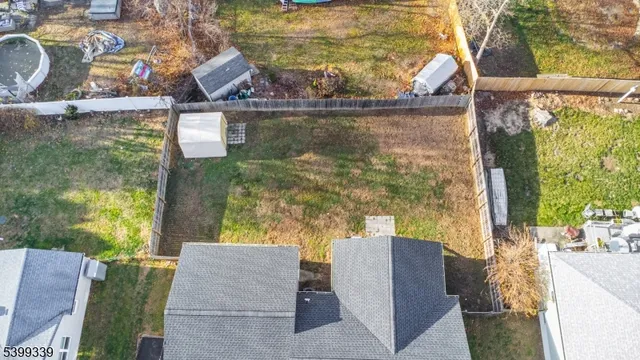 aerial view of a house with a yard and sitting area