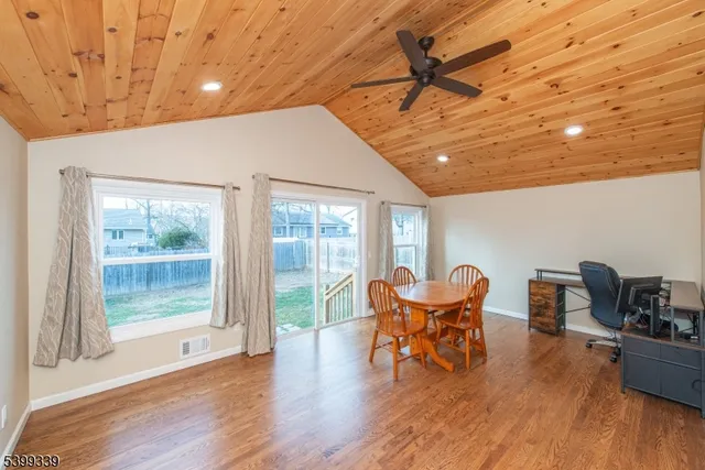 a view of a work space with furniture and wooden floor