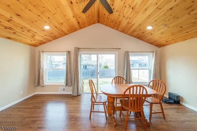 a dining room with furniture and wooden floor