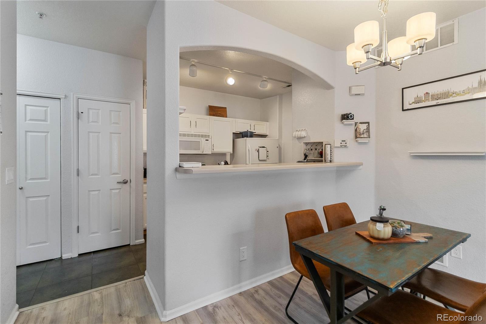 5255 Memphis Street, Unit 702 Denver, CO 80239 - Photo 6 of 30 a view of kitchen and dining area with furniture
