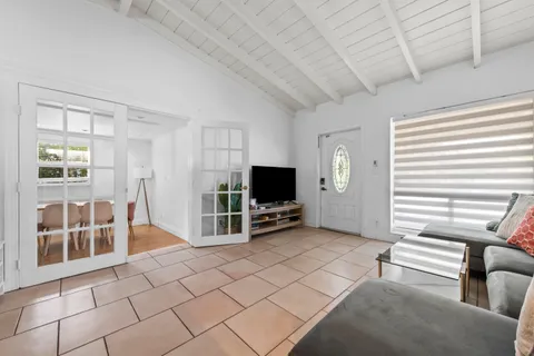 a view of a livingroom with furniture and a flat screen tv