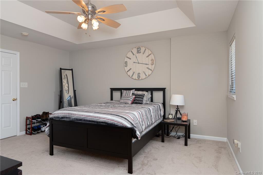 4854 Prosperity Ridge Road Charlotte, NC 28269 - Photo 11 of 22 a bedroom with a bed and a table