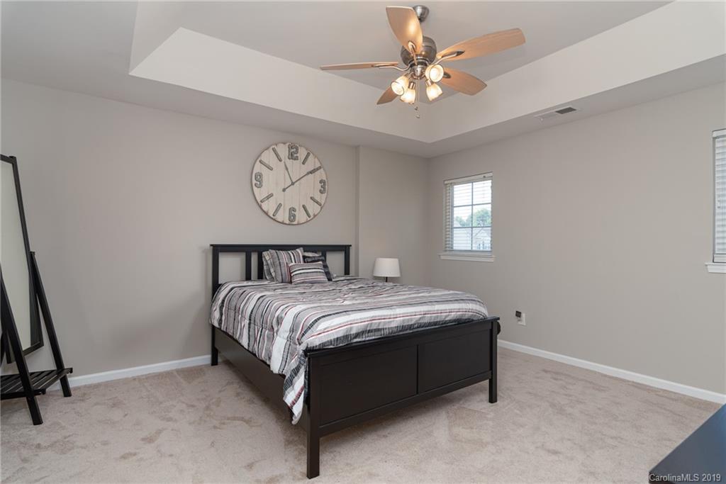 4854 Prosperity Ridge Road Charlotte, NC 28269 - Photo 12 of 22 a bed sitting in a bedroom next to a window