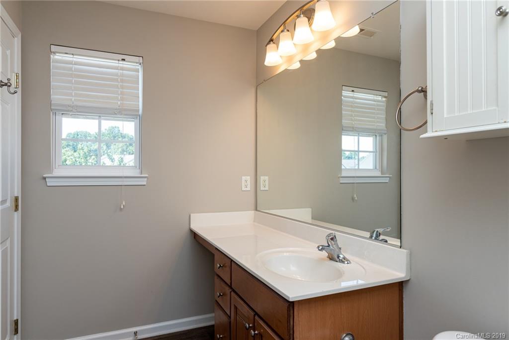 4854 Prosperity Ridge Road Charlotte, NC 28269 - Photo 14 of 22 a bathroom with a sink and a mirror