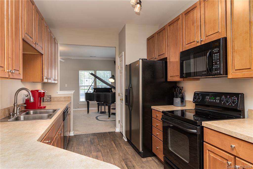 4854 Prosperity Ridge Road Charlotte, NC 28269 - Photo 3 of 22 a kitchen with stainless steel appliances granite countertop a refrigerator stove microwave and sink