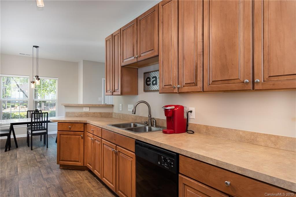 4854 Prosperity Ridge Road Charlotte, NC 28269 - Photo 4 of 22 a kitchen with stainless steel appliances granite countertop wooden cabinets a sink and dishwasher