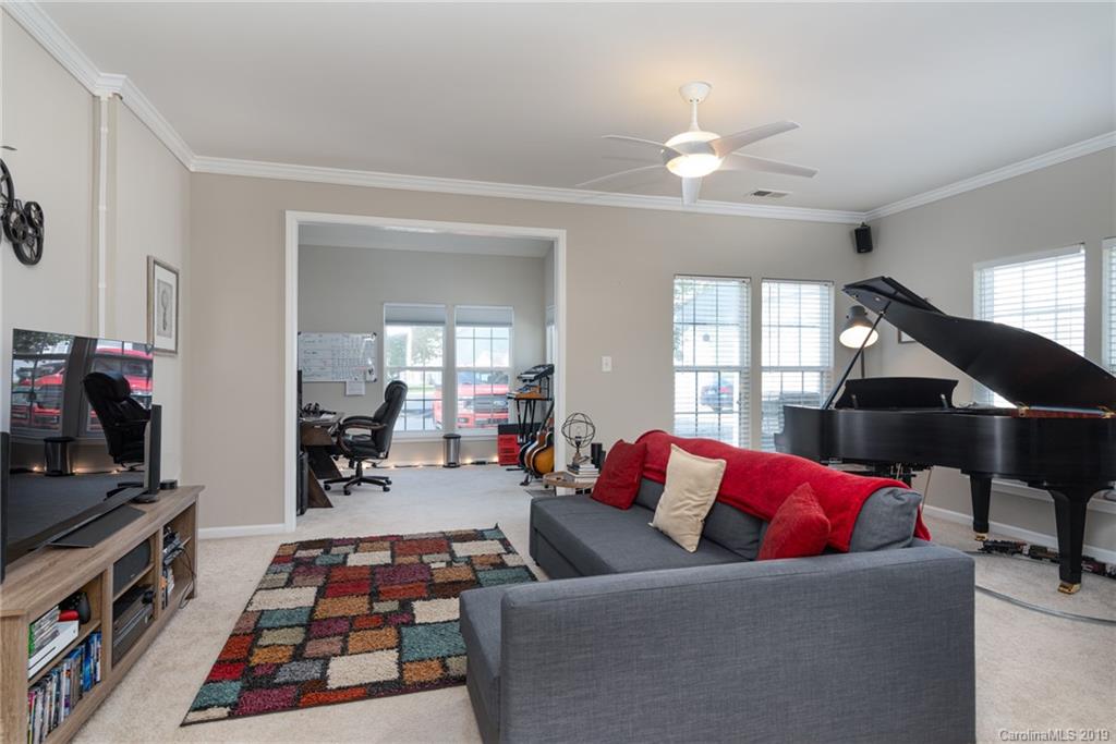 4854 Prosperity Ridge Road Charlotte, NC 28269 - Photo 8 of 22 a living room with furniture and a flat screen tv