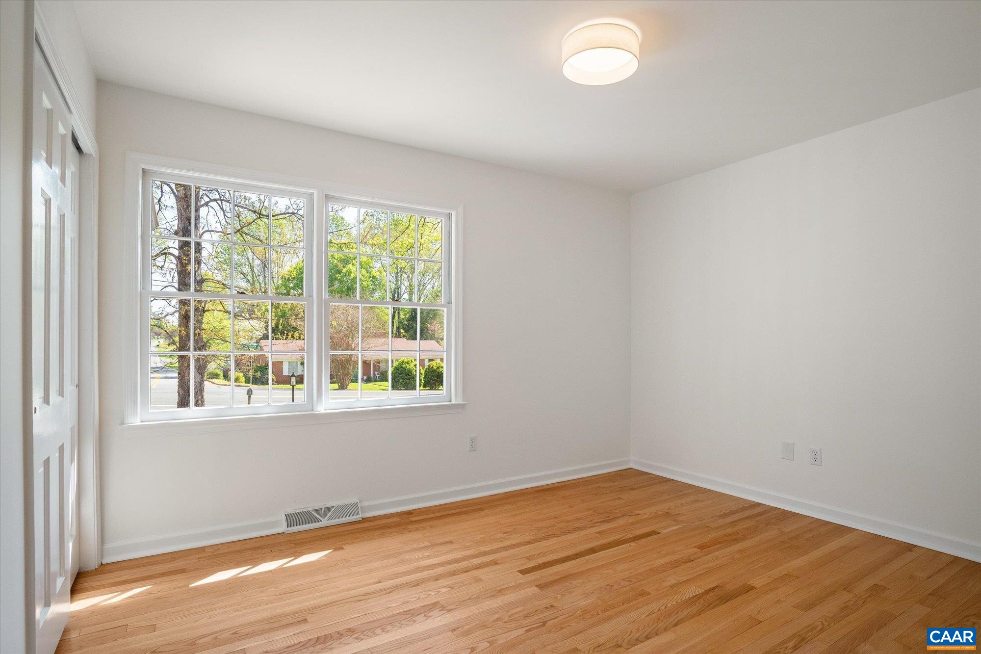 503 Carrsbrook Drive Charlottesville, VA 22901 - Photo 24 of 58 an empty room with wooden floor and windows