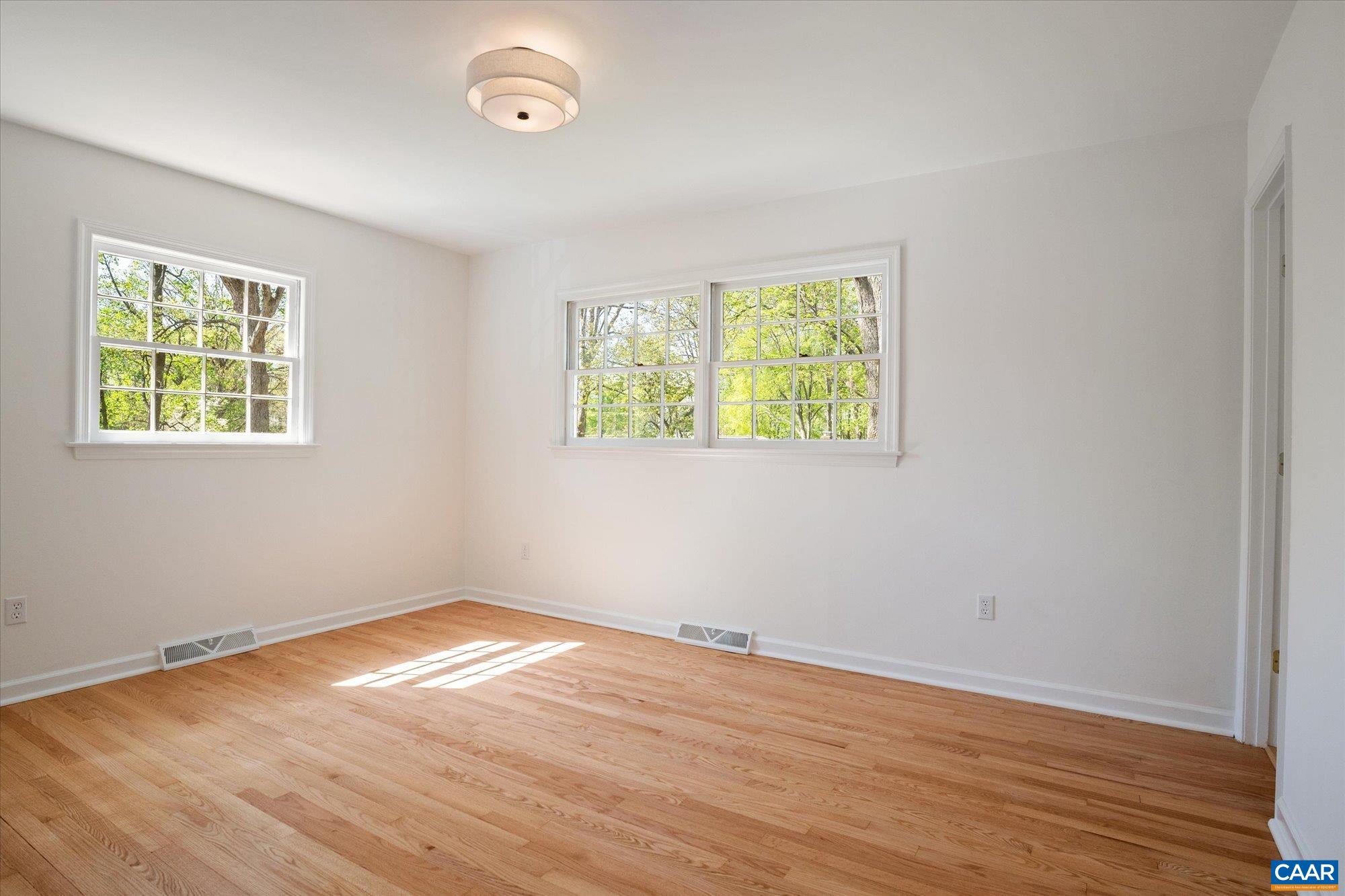 503 Carrsbrook Drive Charlottesville, VA 22901 - Photo 27 of 58 an empty room with wooden floor and windows