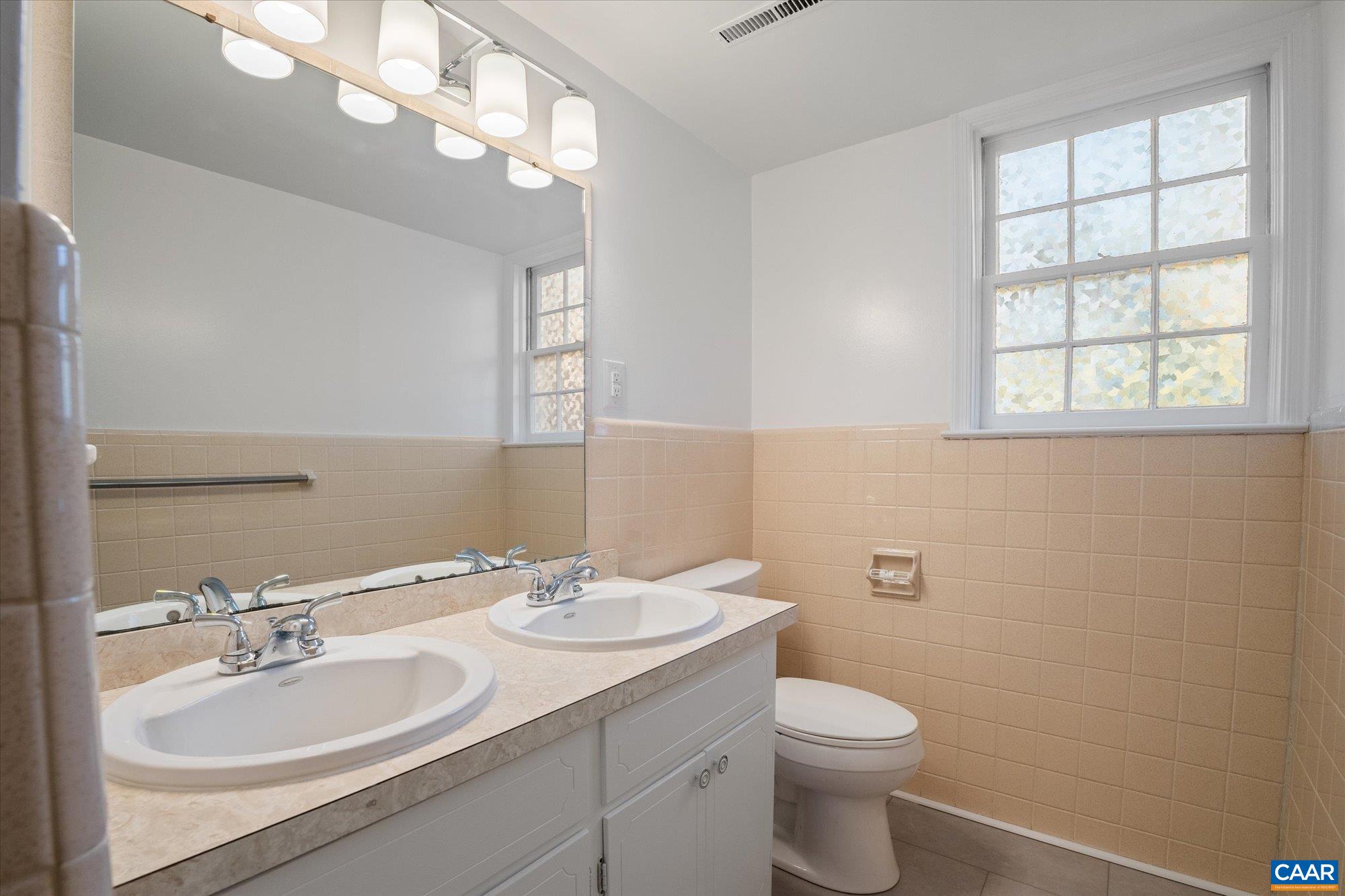 503 Carrsbrook Drive Charlottesville, VA 22901 - Photo 37 of 58 a bathroom with a toilet a sink a mirror a vanity and window