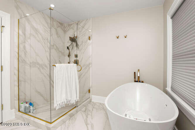 19 Crawford Terrace Riverside, CT 06878 - Photo 14 of 26 a bathroom with a white bath tub a shower and a sink