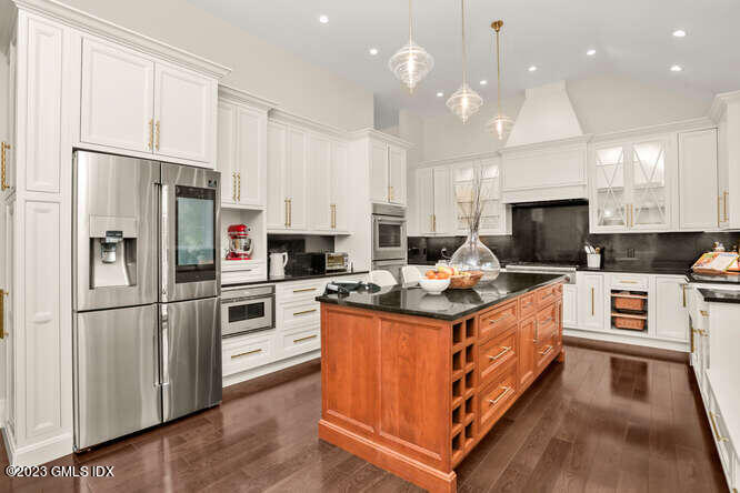 19 Crawford Terrace Riverside, CT 06878 - Photo 7 of 26 a kitchen with granite countertop a stove top oven and refrigerator