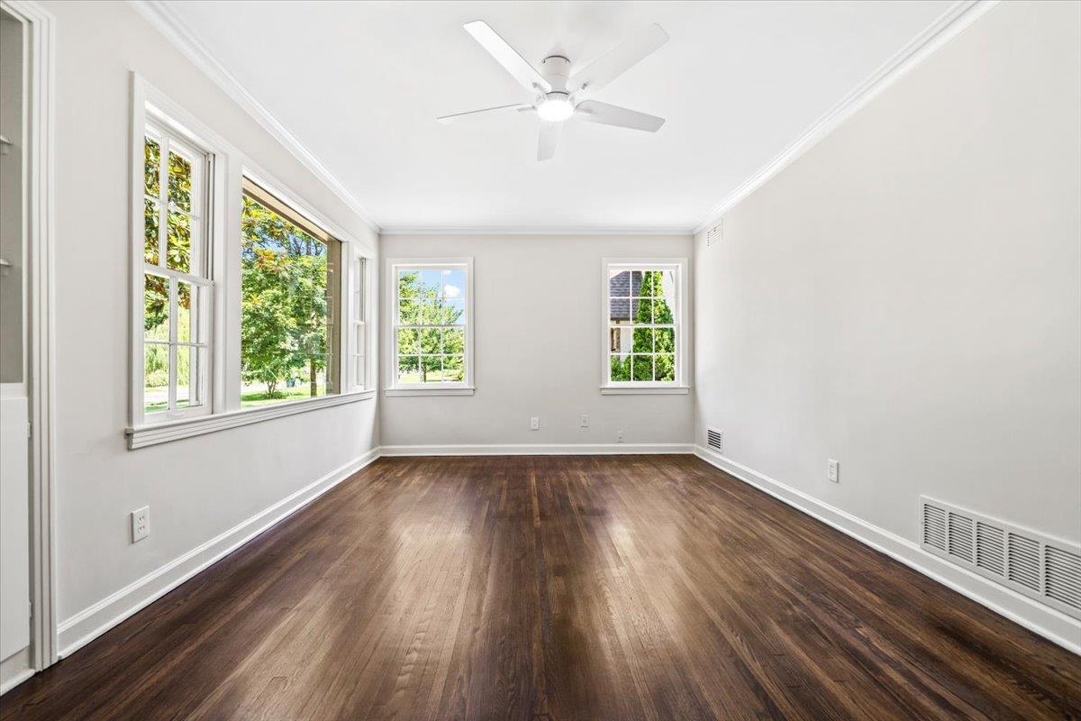 170 South Greer Street Memphis, TN 38111 - Photo 6 of 35 Spacious room with dark wood-finish flooring, white walls, and multiple windows