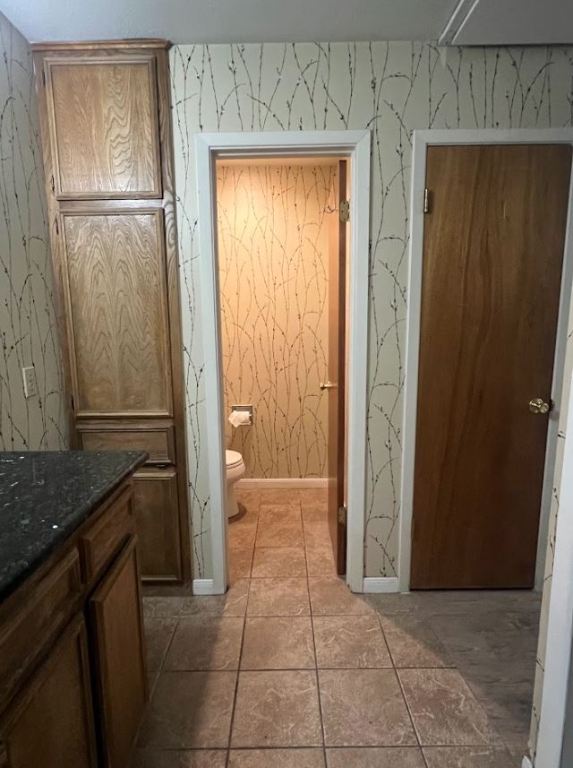 2813 1/2 Rio Grande Street, Unit 5 Austin, TX 78701 - Photo 20 of 21 Bathroom featuring wallpapered walls and vanity