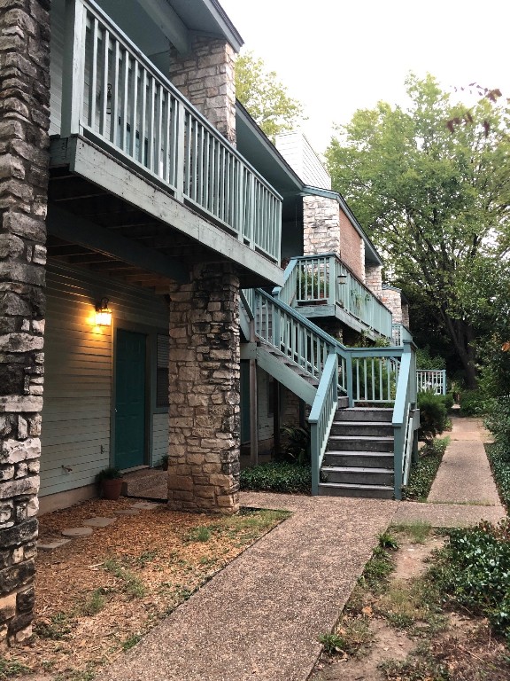 2813 1/2 Rio Grande Street, Unit 5 Austin, TX 78701 - Photo 21 of 21 View of property exterior with a balcony, stone siding, and stairway