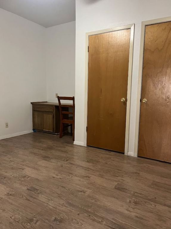 2813 1/2 Rio Grande Street, Unit 5 Austin, TX 78701 - Photo 10 of 21 Unfurnished bedroom with dark wood-style flooring and two closets