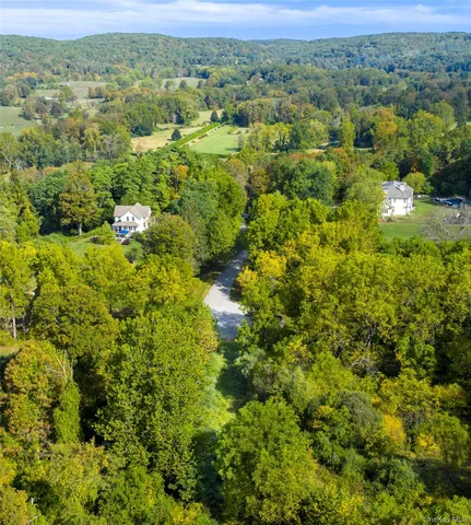 a view of a green field with lots of bushes