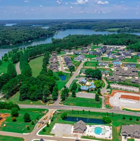 an aerial view of a house with a yard and lake view